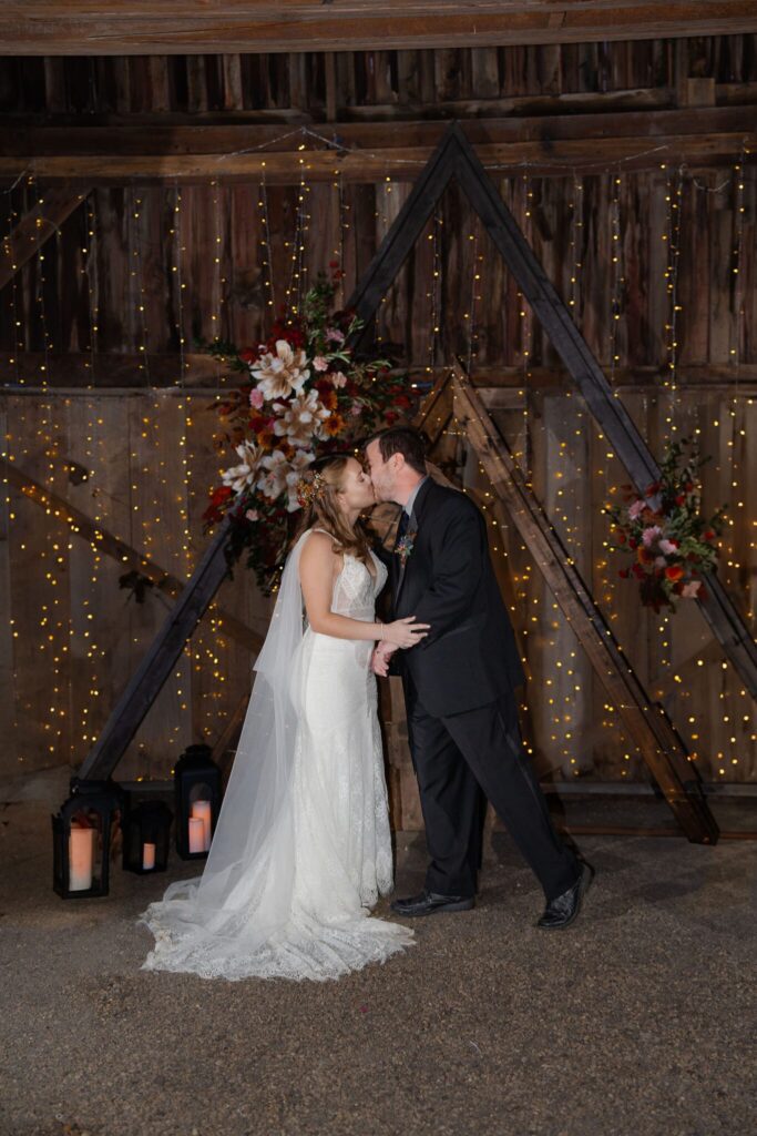 bride and groom kissing at their Circle S Ranch wedding ceremony