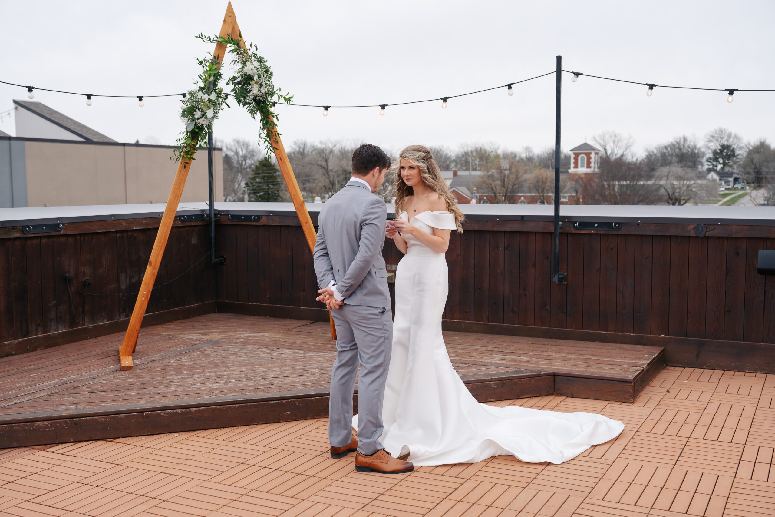 Bride and groom stand on rooftop and exchange wedding vows privately in kansas city