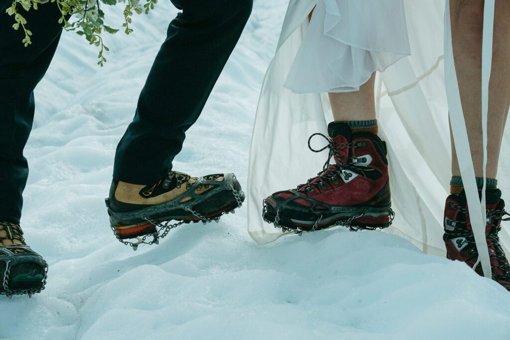 A close up of hiking shoes with ice climbing spikes worn over them. 
