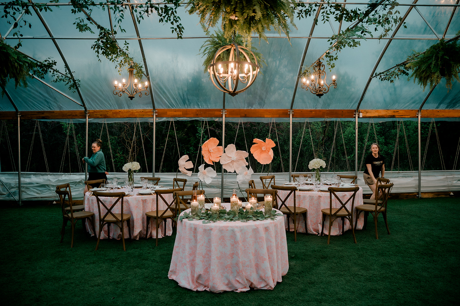 Wedding reception set up in a greenhouse at a Lawrence wedding venue