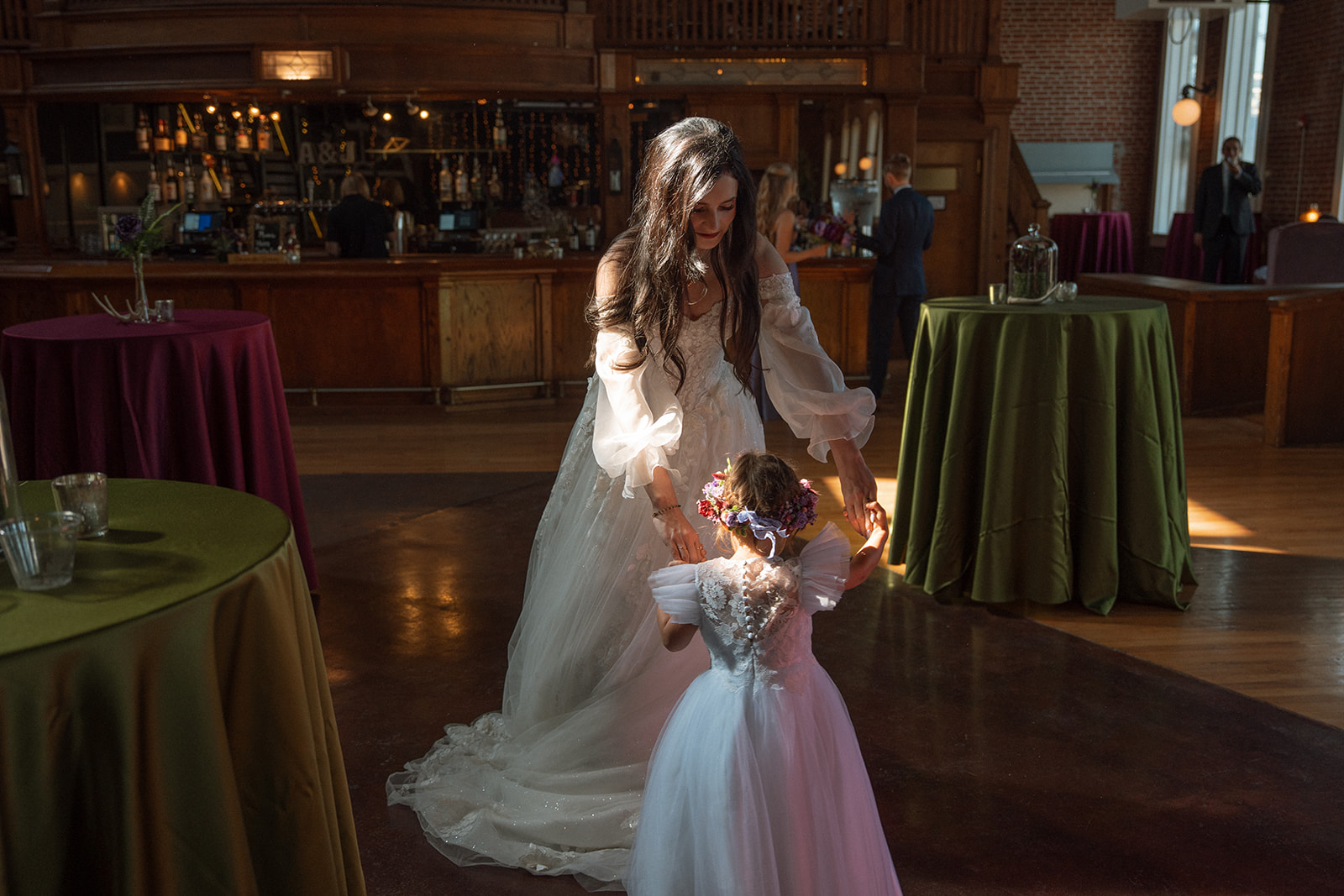 A bride dancing with a small child