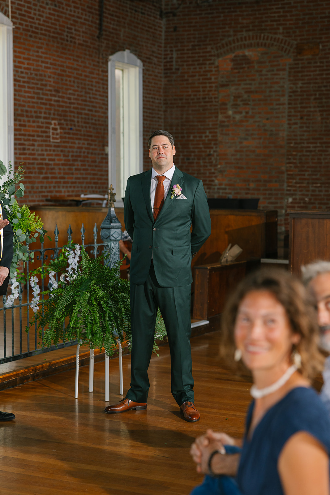 Groom stands at altar