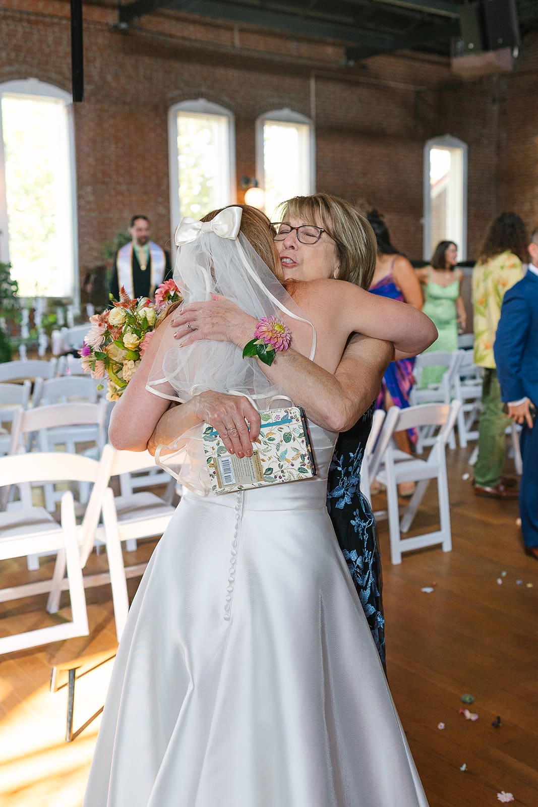 bride and woman hug one another