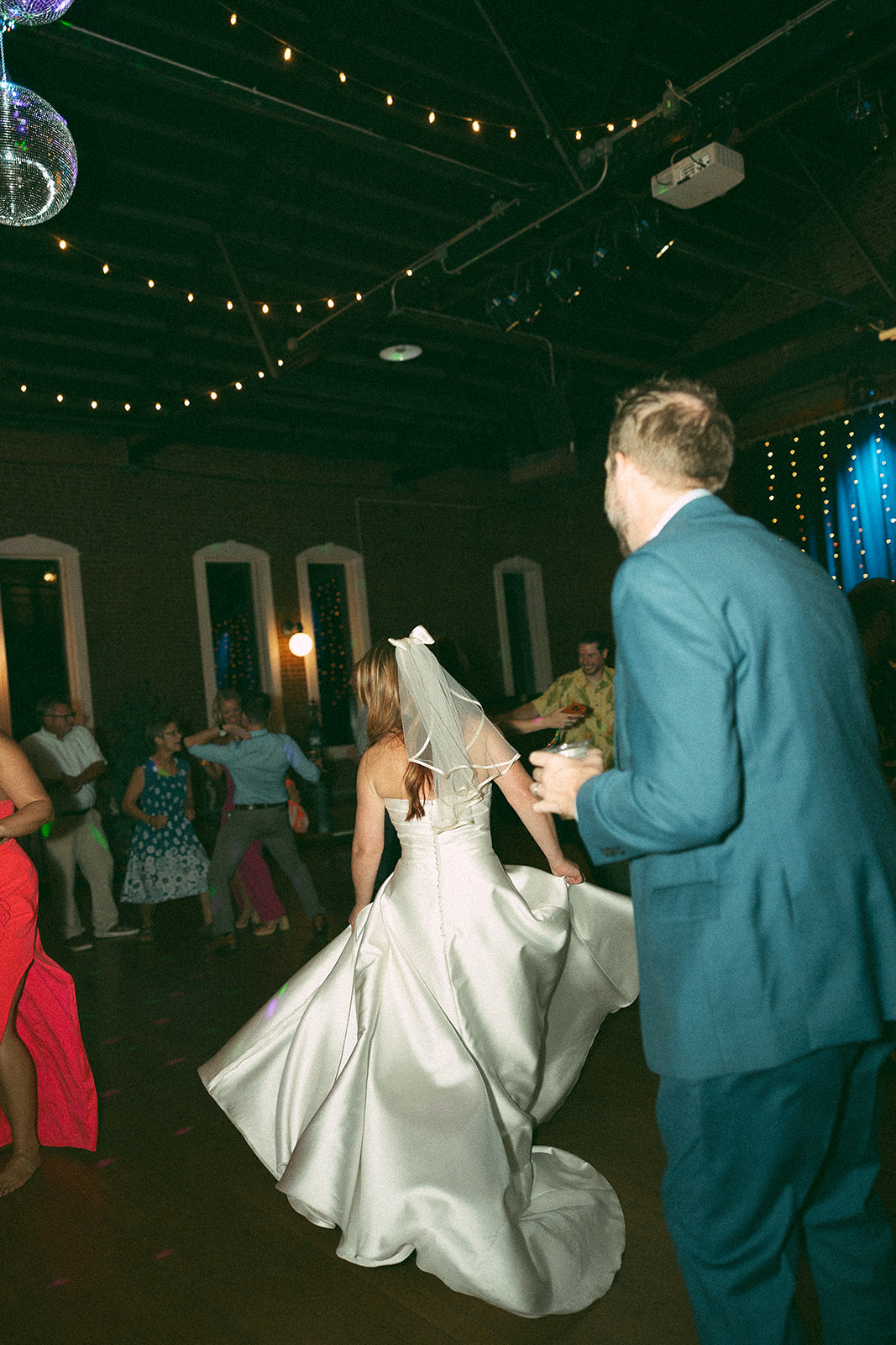 Bride twirls her wedding gown on dance floor