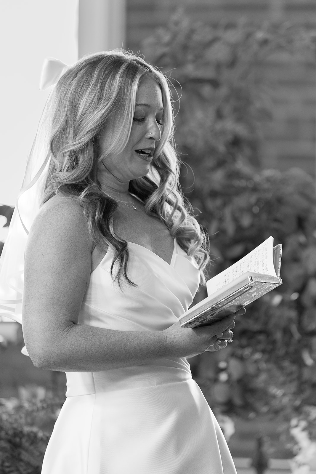 Bride reads vows from vowbook.